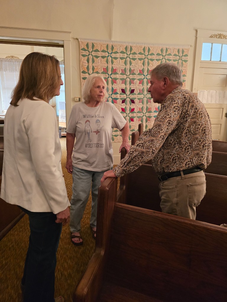 Kelly Grappe for Arkansas Secretary of State — talks with neighbors in a community hall Kelly Grappe, candidate for Arkansas Secretary of State, talks with neighbors in a community hall.