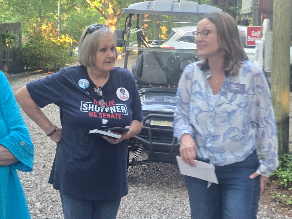 Kelly Grappe for Arkansas Secretary of State — talks with a supporter outdoors beside a campaign stop Kelly Grappe, candidate for Arkansas Secretary of State, talks with a supporter outdoors beside a campaign stop.