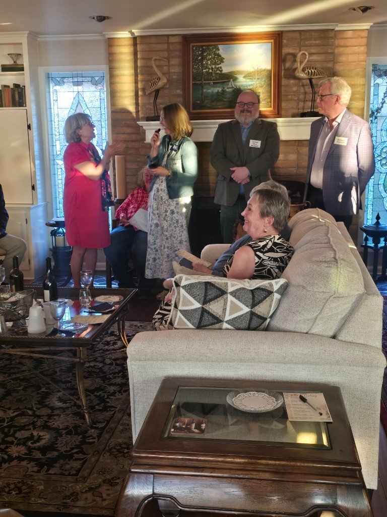 Kelly Grappe for Arkansas Secretary of State — visits with hosts at a living-room gathering Kelly Grappe, candidate for Arkansas Secretary of State, visits with hosts at a living-room gathering.