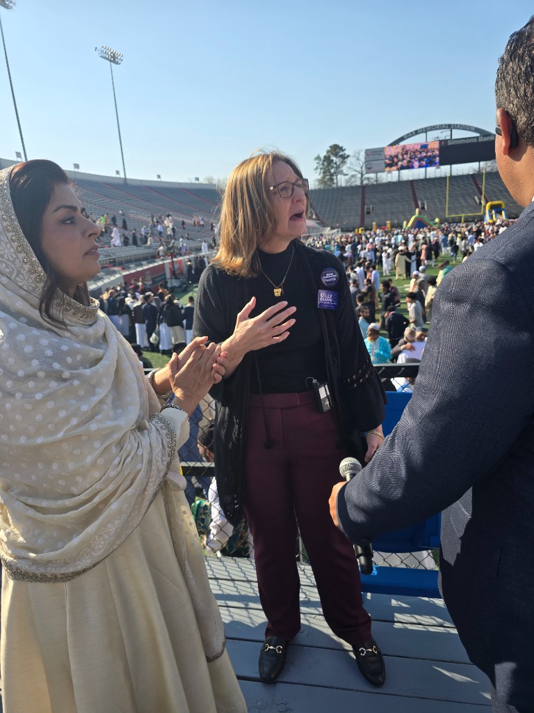 Kelly Grappe speaks on the War Memorial Stadium concourse overlooking a crowded field celebration in Little Rock.