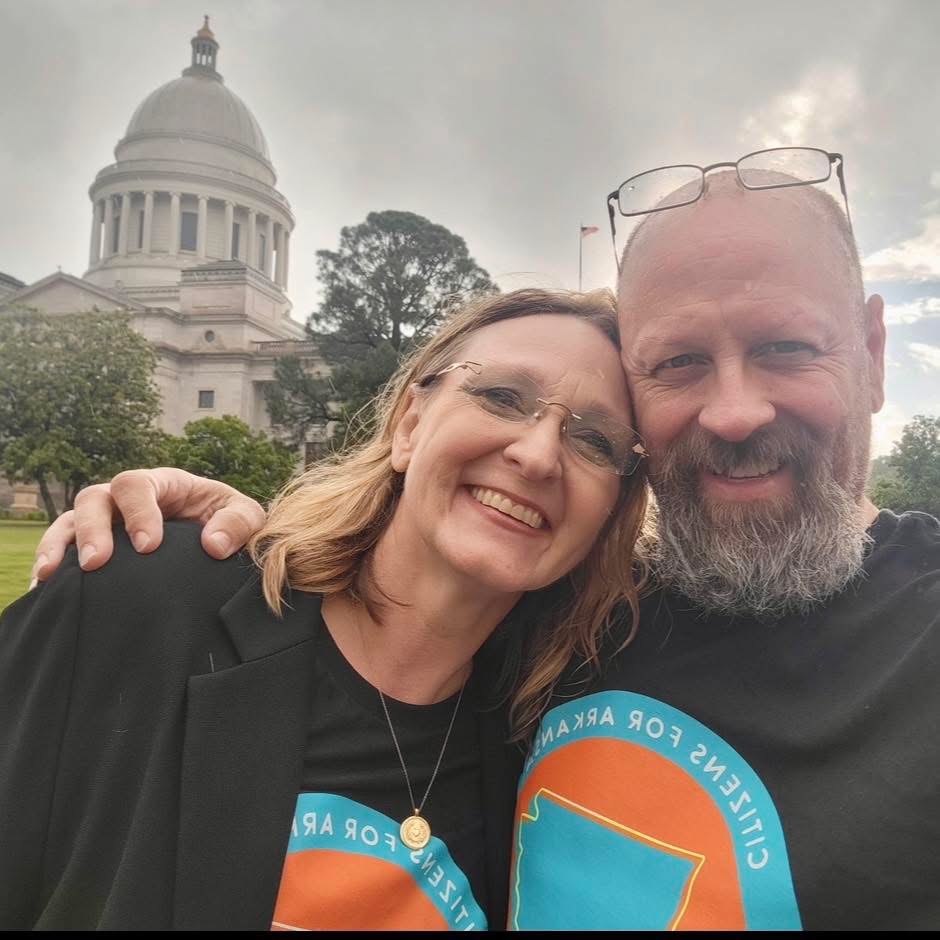 Kelly Grappe for Arkansas Secretary of State — campaign photo Kelly Grappe, candidate for Arkansas Secretary of State. Kelly Grappe smiles in front of the Arkansas State Capitol dome.